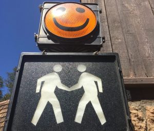 photo of walk sign, hand-in-hand and smiley face by Carol Jorgensen