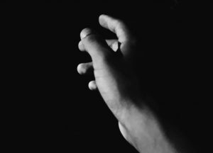photo of hand in darkness by Raphael Brasileiro from Pexels
